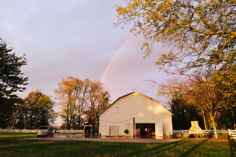 white barn at the potter farm events & wedding venue. bowling green, ky. Rainbow in background